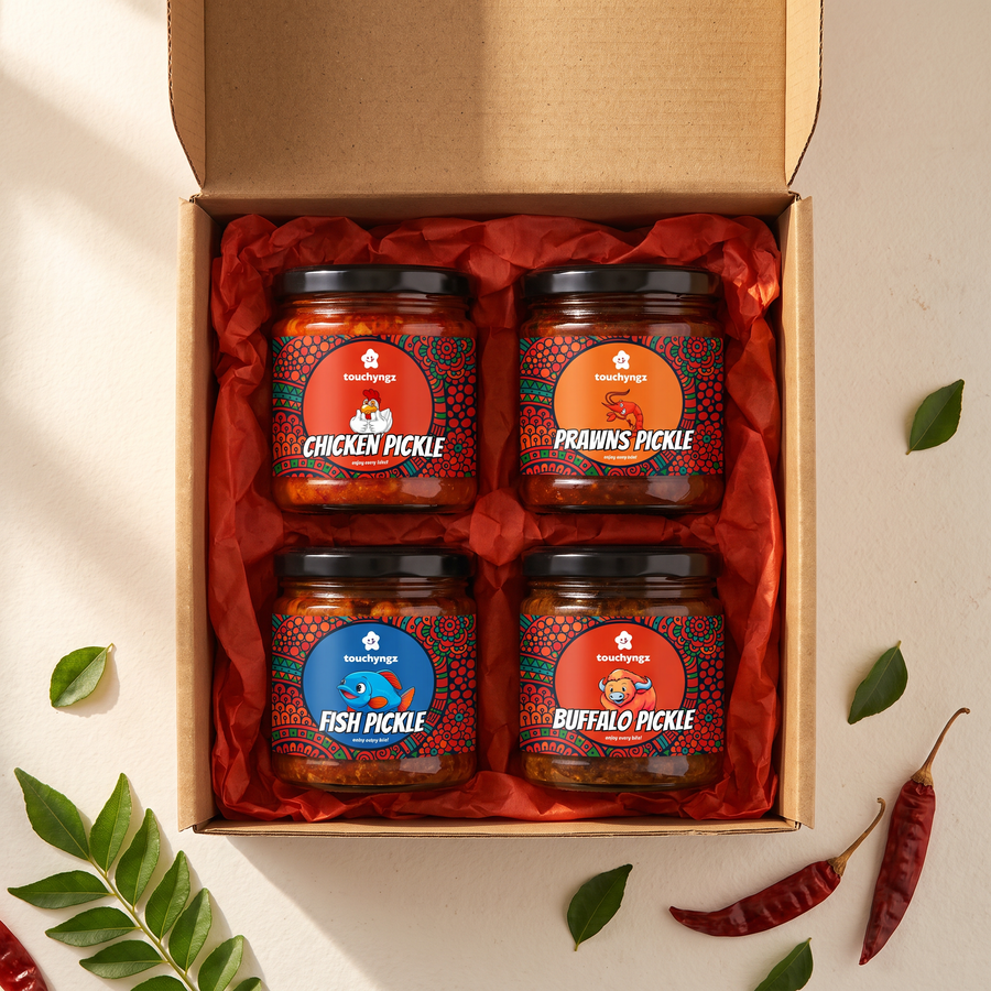 Taste of Kerala Non-Veg Pickle Gift Box by Touchyngz — Chicken, Prawns, Tuna and Buffalo pickle jars in an open kraft gift box with red tissue paper